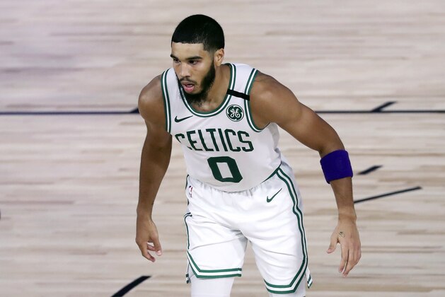 Boston Celtics forward Jayson Tatum (0) wears a purple armband in honor of the late Kobe Bryant during the fourth quarter against the Philadelphia 76ers in Game 4 of an NBA basketball first-round playoff series, Sunday, Aug. 23, 2020, in Lake Buena Vista, Fla. (Kim Klement/Pool Photo via AP)