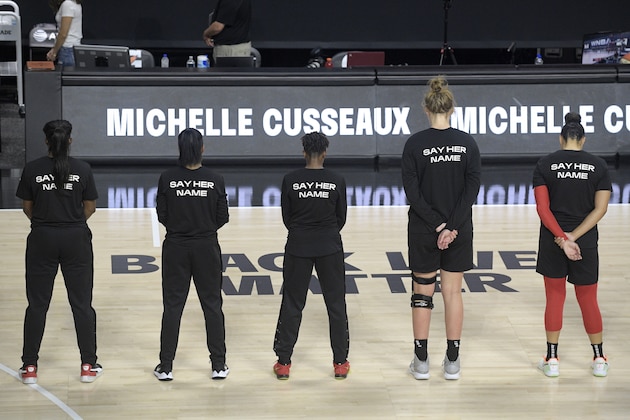 Members of the Las Vegas Aces honor Michelle Cusseaux with a moment of silence before a WNBA basketball game against the Washington Mystics, Saturday, Aug. 15, 2020, in Bradenton, Fla. (AP Photo/Phelan M. Ebenhack)
