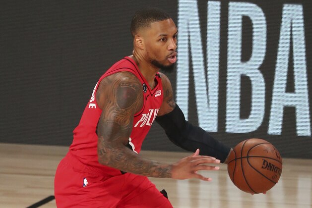 Portland Trail Blazers guard Damian Lillard (0) brings the ball upcourt against the Los Angeles Lakers during the first half of Game 2 of an NBA basketball first-round playoff series, Thursday, Aug. 20, 2020, in Lake Buena Vista, Fla. (Kim Klement/Pool Photo via AP) Portland Trail Blazers guard Damian Lillard (0) brings the ball upcourt against the Los Angeles Lakers during the first half of Game 2 of an NBA basketball first-round playoff series, Thursday, Aug. 20, 2020, in Lake Buena Vista, Fla. (Kim Klement/Pool Photo via AP)