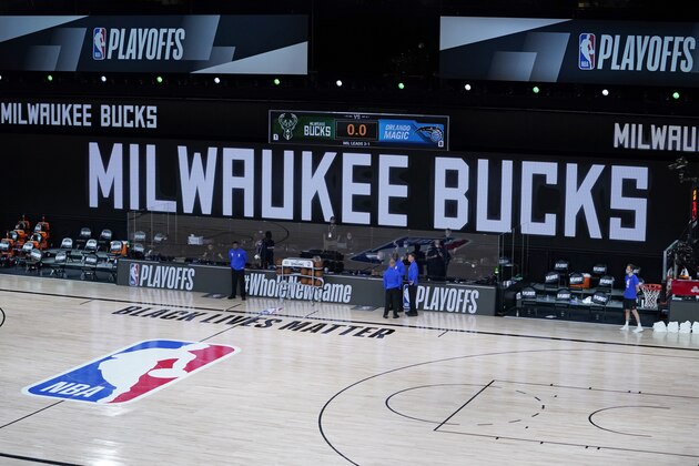 Officials stand beside an empty court at the scheduled start of an NBA basketball first round playoff game between the Milwaukee Bucks and the Orlando Magic, Wednesday, Aug. 26, 2020, in Lake Buena Vista, Fla. The Milwaukee Bucks didn't take the floor in protest against racial injustice and the shooting of Jacob Blake, a Black man, by police in Kenosha, Wisconsin. (AP Photo/Ashley Landis, Pool) Officials stand beside an empty court at the scheduled start of an NBA basketball first round playoff game between the Milwaukee Bucks and the Orlando Magic, Wednesday, Aug. 26, 2020, in Lake Buena Vista, Fla. The Milwaukee Bucks didn't take the floor in protest against racial injustice and the shooting of Jacob Blake, a Black man, by police in Kenosha, Wisconsin. (AP Photo/Ashley Landis, Pool)