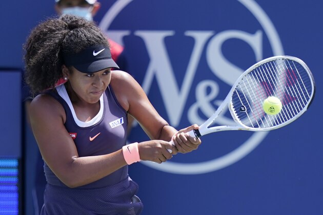 Naomi Osaka, of Japan, returns a shot to Anett Kontaveit, of Estonia, during the quarterfinals at the Western & Southern Open tennis tournament Wednesday, Aug. 26, 2020, in New York. (AP Photo/Frank Franklin II)