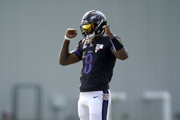 Baltimore Ravens quarterback Lamar Jackson reacts after running a drill during an NFL football training camp practice, Tuesday, Aug. 25, 2020, in Owings Mills, Md. (AP Photo/Julio Cortez)