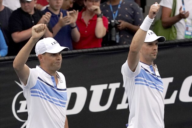 Bob, left, and Mike Bryan of the U.S. gesture to the crowd after their first round doubles win over India's Rohan Bopanna and Japan's Yasutaka Uchiyama at the Australian Open tennis championship in Melbourne, Australia, Wednesday, Jan. 22, 2020.(AP Photo/Lee Jin-man)