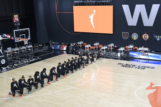 Members of the Connecticut Sun team kneel during the playing of the national anthem before a WNBA basketball game against the Indiana Fever, Tuesday, Aug. 18, 2020, in Bradenton, Fla. (AP Photo/Phelan M. Ebenhack)