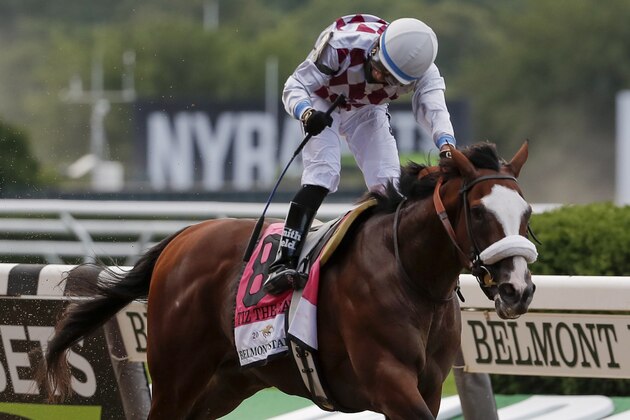 Tiz the Law (8), with jockey Manny Franco up, crosses the finish line in front of an empty grandstand to win the152nd running of the Belmont Stakes horse race, Saturday, June 20, 2020, in Elmont, N.Y. (AP Photo/Seth Wenig)