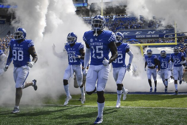 Kentucky Wildcats players run onto the field before the first half an NCAA college football game against Murray State in Lexington, Ky., Saturday, Sept. 15, 2018. (AP Photo/Bryan Woolston)