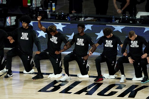 Brooklyn Nets' Lance Thomas, second from left, gestures as he and teammates kneel in honor of the Black Lives Matter movement prior to an NBA basketball game against the Portland Trail Blazers Thursday, Aug. 13, 2020 in Lake Buena Vista, Fla. (AP Photo/Ashley Landis, Pool) Brooklyn Nets' Lance Thomas, second from left, gestures as he and teammates kneel in honor of the Black Lives Matter movement prior to an NBA basketball game against the Portland Trail Blazers Thursday, Aug. 13, 2020 in Lake Buena Vista, Fla. (AP Photo/Ashley Landis, Pool)