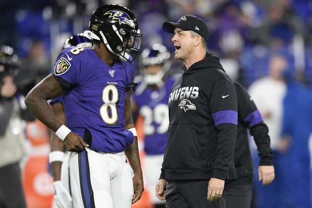 Baltimore Ravens quarterback Lamar Jackson (8) speaks with Baltimore Ravens head coach John Harbaugh before an NFL divisional playoff football game against the Tennessee Titans, Saturday, Jan. 11, 2020, in Baltimore. (AP Photo/Nick Wass)