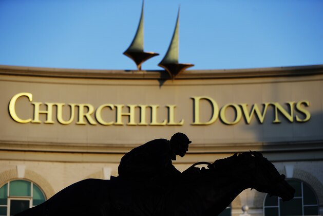A statue of Barbaro is silhouetted at the entrance of Churchill Downs, Wednesday, May 6, 2020, in Louisville, Ky. The Kentucky Derby has been postponed until Sept. 5 because of the coronavirus. (AP Photo/Darron Cummings)