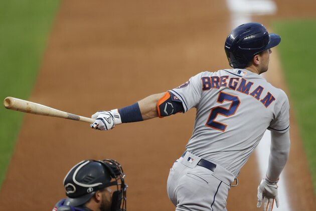 Houston Astros' Alex Bregman follows the flight of his double to lead off the fourth inning of a baseball game Wednesday, Aug. 19, 2020, in Denver. Bregman limped to second base and was removed from the game before play resumed. (AP Photo/David Zalubowski)