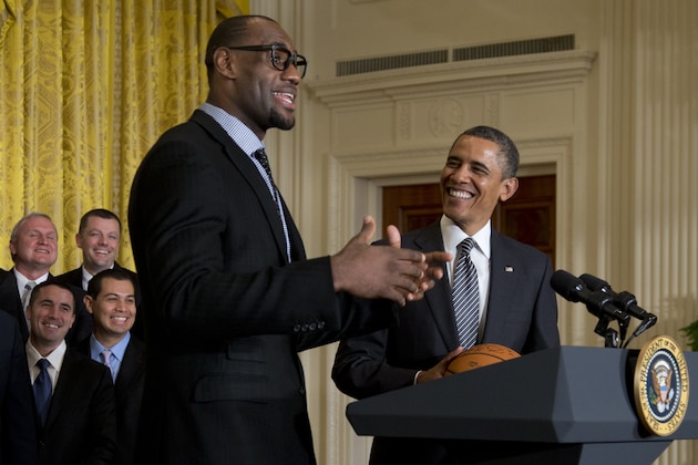 President Barack Obama looks to Miami Heat forward LeBron James as he welcomes the NBA basketball champion Miami Heat, to the East Room of the White House, Monday, Jan. 28, 2013, in Washington. (AP Photo/Carolyn Kaster)