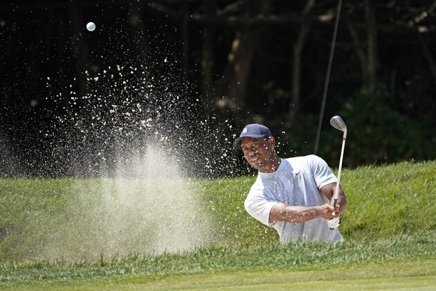 Tiger Woods hits from a bunker on the first hole during the second round of the BMW Championship golf tournament, Friday, Aug. 28, 2020, at Olympia Fields Country Club in Olympia Fields, Ill. (AP Photo/Charles Rex Arbogast)
