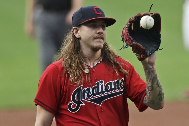Cleveland Indians starting pitcher Mike Clevinger gets another ball after giving up a home run in the first inning in a baseball game, Wednesday, Aug. 26, 2020, in Cleveland. (AP Photo/Tony Dejak)