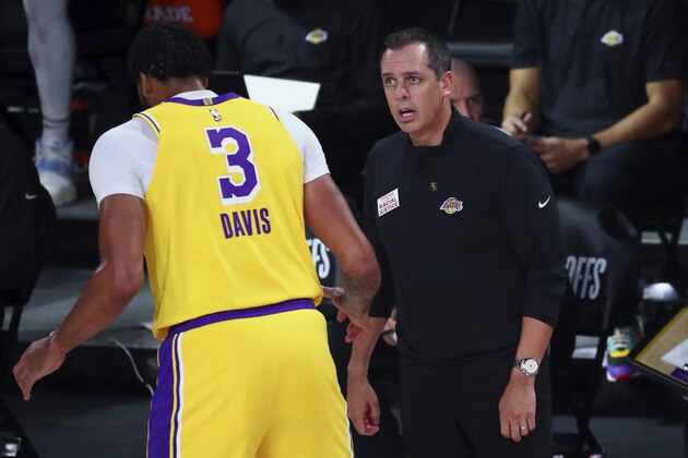 Los Angeles Lakers head coach Frank Vogel, right, talks with forward Anthony Davis (3) during the first half of Game 2 of an NBA basketball first-round playoff series against the Portland Trail Blazers, Thursday, Aug. 20, 2020, in Lake Buena Vista, Fla. (Kim Klement/Pool Photo via AP)