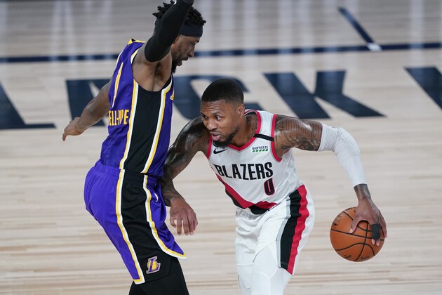 Portland Trail Blazers guard Damian Lillard (0) drives around Los Angeles Lakers guard Kentavious Caldwell-Pope (1) during the first half of an NBA basketball first round playoff game, Saturday, Aug. 22, 2020, in Lake Buena Vista, Fla. (AP Photo/Ashley Landis, Pool)