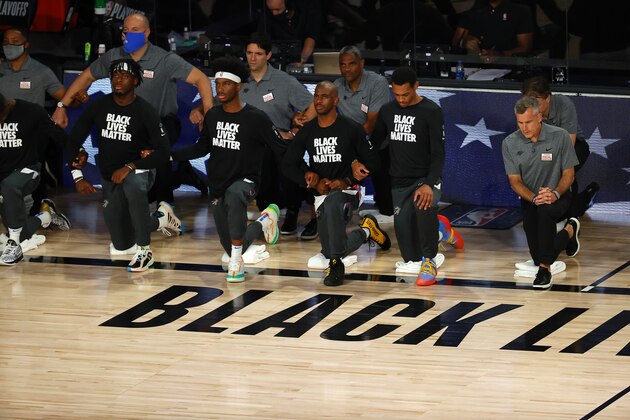 Players from the Oklahoma City Thunder take a knee during the national anthem before Game 4 of an NBA basketball first-round playoff series against the Houston Rockets, Monday, Aug. 24, 2020, in Lake Buena Vista, Fla. (Kevin C. Cox/Pool Photo via AP)