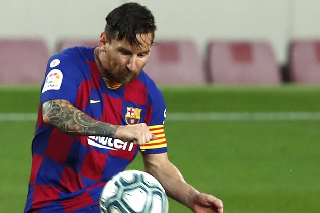 Barcelona's Lionel Messi kicks the ball during a Spanish La Liga soccer match between Barcelona and Osasuna at the Camp Nou stadium in Barcelona, Spain, Thursday, July 16, 2020. (AP Photo/Joan Monfort)