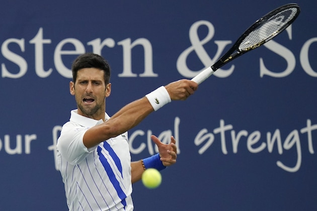 Novak Djokovic, of Serbia, returns a shot by Milos Raonic, of Canada, during the finals of the Western & Southern Open tennis tournament Saturday, Aug. 29, 2020, in New York. (AP Photo/Frank Franklin II)