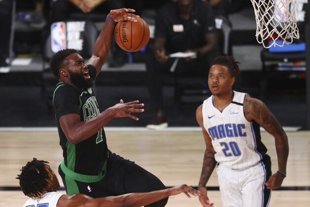 Boston Celtics guard Jaylen Brown (7) loses the ball as he drives to the basket against Orlando Magic forward Wes Iwundu (25) during the first half of an NBA basketball game Sunday, Aug. 9, 2020, in Lake Buena Vista, Fla. (Kim Klement/Pool Photo via AP)