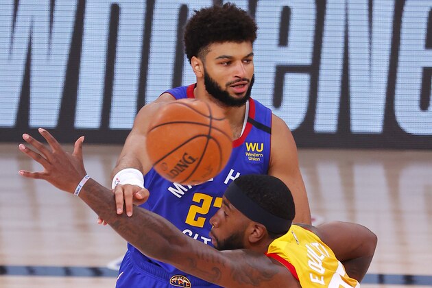 Denver Nuggets' Jamal Murray (27) passes against Utah Jazz's Royce O'Neale during Game 3 of an NBA basketball first-round playoff series, Friday, Aug. 21, 2020, in Lake Buena Vista, Fla. (Mike Ehrmann/Pool Photo via AP)