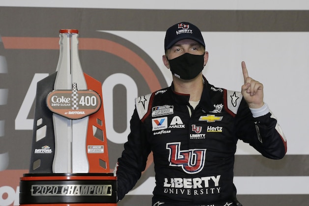 William Byron stands with his trophy in Victory Lane after winning the NASCAR Cup Series auto race at Daytona International Speedway, Saturday, Aug. 29, 2020, in Daytona Beach, Fla. (AP Photo/Terry Renna)