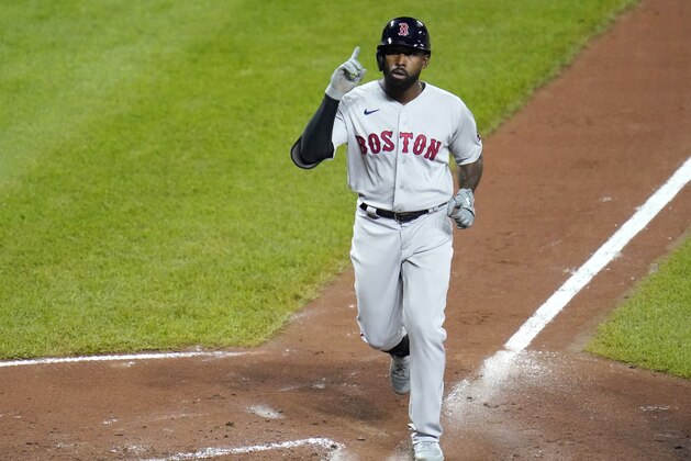Boston Red Sox's Jackie Bradley Jr. gestures before crossing home plate after hitting a solo home run off Baltimore Orioles starting pitcher Alex Cobb during the fifth inning of a baseball game, Saturday, Aug. 22, 2020, in Baltimore. (AP Photo/Julio Cortez)