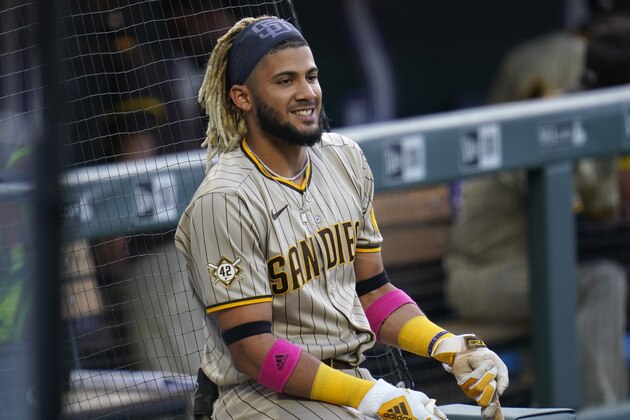 San Diego Padres' Fernando Tatis Jr. smiles as he waits to bat in the on-deck circle in the first inning of a baseball game against the Colorado Rockies, Saturday, Aug. 29, 2020, in Denver. (AP Photo/David Zalubowski)
