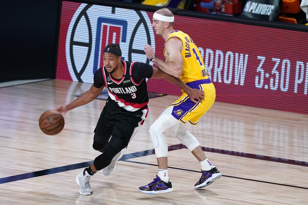 Portland Trail Blazers' CJ McCollum (3) drives against Los Angeles Lakers' Alex Caruso (4) during the second half of an NBA basketball first round playoff game Saturday, Aug. 29, 2020, in Lake Buena Vista, Fla. (AP Photo/Ashley Landis)
