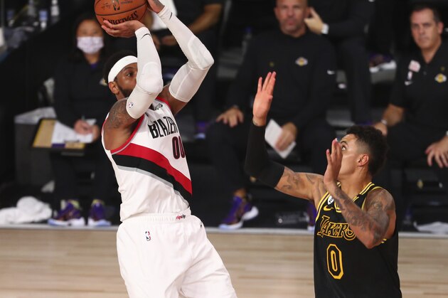 Portland Trail Blazers forward Carmelo Anthony (00) shoots against Los Angeles Lakers forward Kyle Kuzma (0) in the second half of Game 4 of an NBA basketball first-round playoff series, Monday, Aug. 24, 2020, in Lake Buena Vista, Fla. (Kim Klement/Pool Photo via AP)