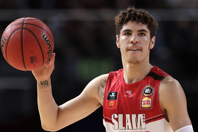 FILE - In this Nov. 17, 2019, file photo, LaMelo Ball of the Illawarra Hawks carries the ball up during their game against the Sydney Kings in the Australian Basketball League in Sydney.  LaMelo Ball's bone bruise on his left foot is expected to keep him out of the Illawarra Hawks lineup for the remainder of the National Basketball League season in Australia. The 18-year-old American, who joined Illawarra as part of the NBL's Next Stars program, is expected to be a first-round pick in this year's NBA draft.(AP Photo/Rick Rycroft, File)