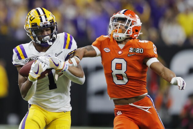 LSU wide receiver Ja'Marr Chase, left, catches a pass in front of Clemson cornerback A.J. Terrell during the first half of a NCAA College Football Playoff national championship game Monday, Jan. 13, 2020, in New Orleans. (AP Photo/Gerald Herbert)