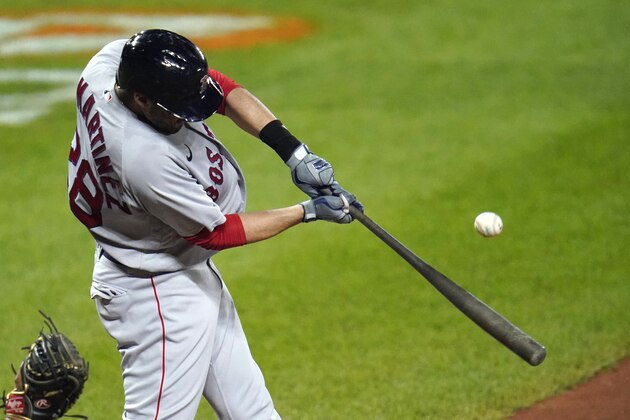 Boston Red Sox's J.D. Martinez swings at a pitch from the Baltimore Orioles during the ninth inning of a baseball game, Thursday, Aug. 20, 2020, in Baltimore. The Red Sox won 7-1. (AP Photo/Julio Cortez)