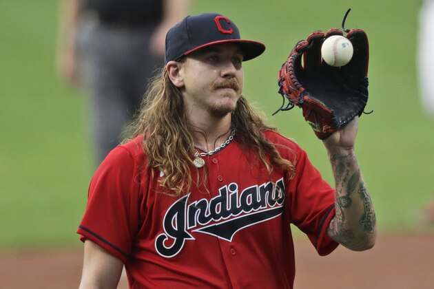Cleveland Indians starting pitcher Mike Clevinger gets another ball after giving up a home run in the first inning in a baseball game, Wednesday, Aug. 26, 2020, in Cleveland. (AP Photo/Tony Dejak)