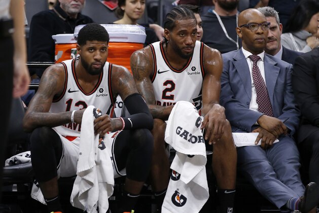 Los Angeles Clippers Paul George, left, and Kawhi Leonard, right, watch the closing moments of the Clippers 105-87 win over the Sacramento Kings in an NBA basketball game in Sacramento, Calif., Tuesday, Dec. 31, 2019. (AP Photo/Rich Pedroncelli) Los Angeles Clippers Paul George, left, and Kawhi Leonard, right, watch the closing moments of the Clippers 105-87 win over the Sacramento Kings in an NBA basketball game in Sacramento, Calif., Tuesday, Dec. 31, 2019. (AP Photo/Rich Pedroncelli)