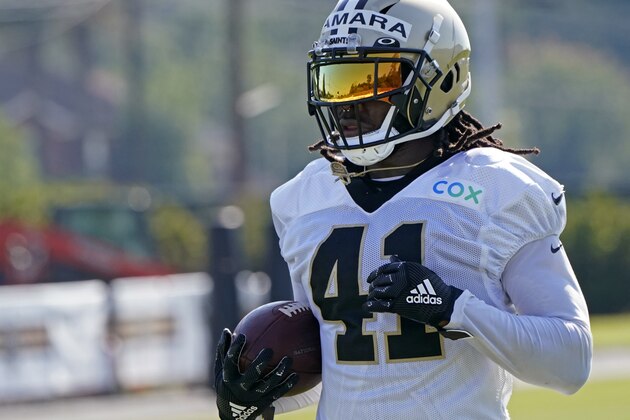 A reflection of the training facility is seen in the visor of New Orleans Saints running back Alvin Kamara (41) as he runs through drills during practice at their NFL football training facility in Metairie, La., Saturday, Aug. 22, 2020. (AP Photo/Gerald Herbert, pool)