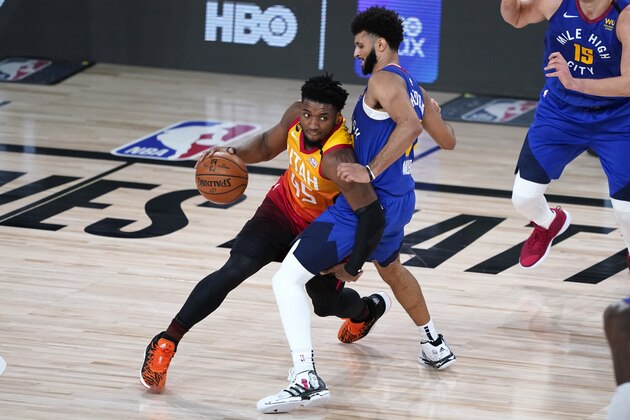Utah Jazz's Donovan Mitchell (45) tries to drive around Denver Nuggets' Jamal Murray during the second half of an NBA basketball first round playoff game Sunday, Aug. 30, 2020, in Lake Buena Vista, Fla. (AP Photo/Ashley Landis)