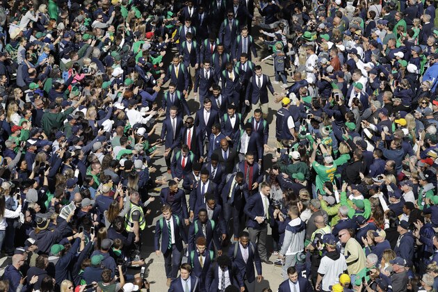 Notre Dame players greet fans as they enter the stadium before an NCAA college football game against Bowling Green, Saturday, Oct. 5, 2019, in South Bend, Ind. (AP Photo/Darron Cummings)