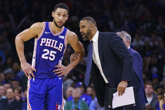 Philadelphia 76ers' Ben Simmons, left, listens to assistant coach Ime Udoka, right, during the second half of an NBA basketball game against the Sacramento Kings, Wednesday, Nov. 27, 2019, in Philadelphia. The 76ers won 97-91. (AP Photo/Chris Szagola)