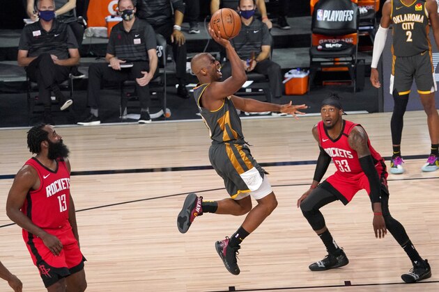 Oklahoma City Thunder's Chris Paul (3) goes up for a shot between Houston Rockets' James Harden (13) and Robert Covington (33) during the second half of an NBA first-round playoff basketball game, Monday, Aug. 31, 2020, in Lake Buena Vista, Fla. (AP Photo/Mark J. Terrill)
