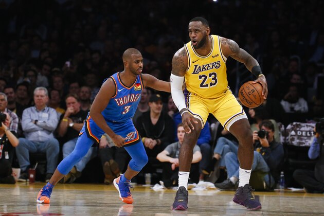 Los Angeles Lakers' LeBron James (23) dribbles against Oklahoma City Thunder's Chris Paul (3) during the second half of an NBA basketball game, Tuesday, Nov. 19, 2019, in Los Angeles. The Lakers won 112-107. (AP Photo/Ringo H.W. Chiu)