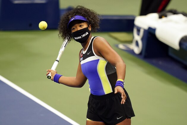 Naomi Osaka, of Japan, wears a mask in honor of Breonna Taylor as she celebrates after defeating Misaki Doi, of Japan, during the first round of the US Open tennis championships, Monday, Aug. 31, 2020, in New York. (AP Photo/Frank Franklin II)