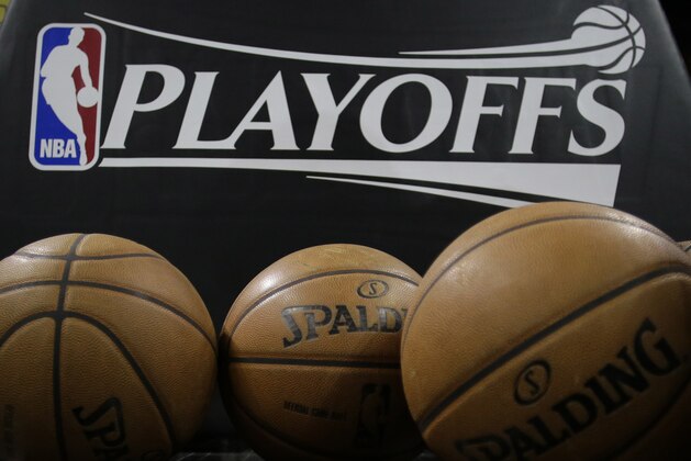 A logo for the NBA playoffs and official basketballs are seen on the court prior to Game 1 of an NBA basketball playoffs basketball game between the Los Angeles Lakers and San Antonio Spurs, Sunday, April 21, 2013, in San Antonio, Texas. (AP Photo/Eric Gay)
