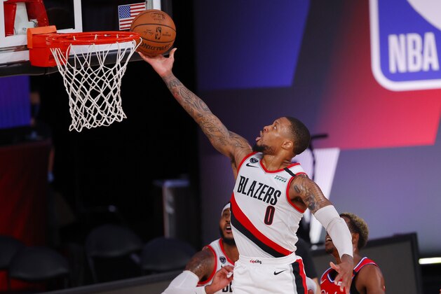 Damian Lillard of the Portland Trail Blazers goes up for a shot against the Philadelphia 76ers during the first half of an NBA basketball game Sunday, Aug. 9, 2020, in Lake Buena Vista, Fla. (Kevin C. Cox/Pool Photo via AP)