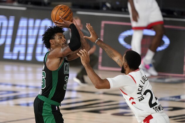 Boston Celtics' Marcus Smart (36) takes a shot over Toronto Raptors' Norman Powell (24) in the second half of an NBA conference semifinal playoff basketball game, Tuesday, Sept. 1, 2020, in Lake Buena Vista, Fla. (AP Photo/Mark J. Terrill)