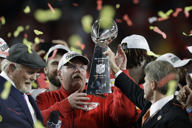 Kansas City Chiefs chairman Clark Hunt, right, hands the trophy to head coach Andy Reid after the chiefs defeated the San Francisco 49ers in the NFL Super Bowl 54 football game Sunday, Feb. 2, 2020, in Miami Gardens, Fla. (AP Photo/Chris O'Meara)