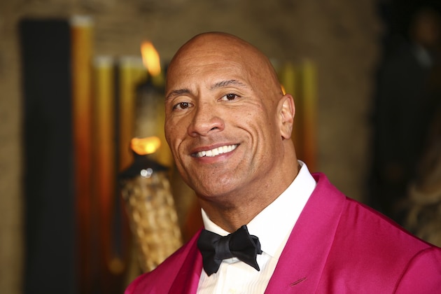FILE - In this Dec. 5, 2019 file photo, actor Dwayne Johnson poses for photographers upon arrival at the premiere of the film 'Jumanji The Next Level', in central London.   Johnson will revisit his younger years in a new NBC comedy series called “The Rock,” which is the retired pro wrestler's nickname. NBC said Saturday, Jan. 11, 2020  that it's ordered 11 episodes of the show inspired by Johnson, who will appear and also serve as an executive producer.  (Photo by Joel C Ryan/Invision/AP)