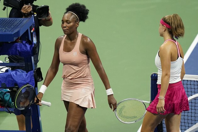 Venus Williams, of the United States, left, leaves the court along with Karolina Muchova, of the Czech Republic, right, after their first round match at the U.S. Open tennis championships, Tuesday, Sept. 1, 2020, in New York. Muchova won the match. (AP Photo/Frank Franklin II)