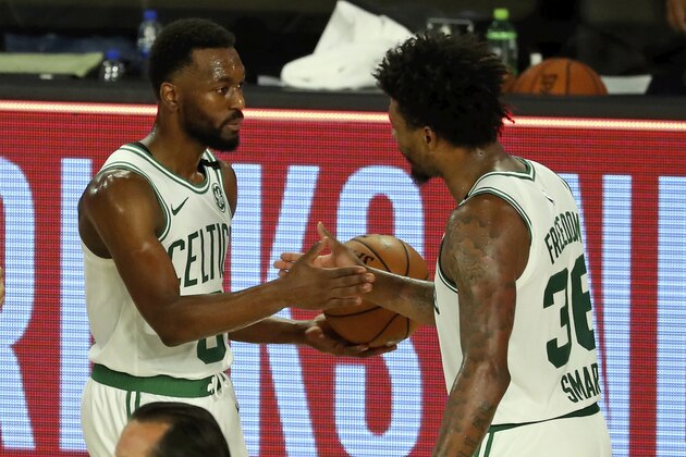 Boston Celtics guard Kemba Walker (8) and Boston Celtics guard Marcus Smart (36) celebrate after defeating the Philadelphia 76ers in Game 3 of an NBA basketball first-round playoff series, Friday, Aug. 21, 2020, in Lake Buena Vista, Fla. (Kim Klement/Pool Photo via AP)
