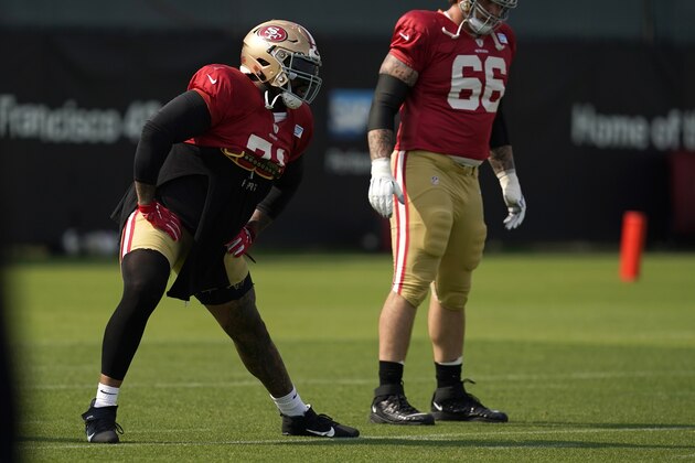 San Francisco 49ers' Trent Williams, left, stretches during NFL football practice in Santa Clara, Calif., Tuesday, Aug. 18, 2020. (AP Photo/Jeff Chiu, Pool)