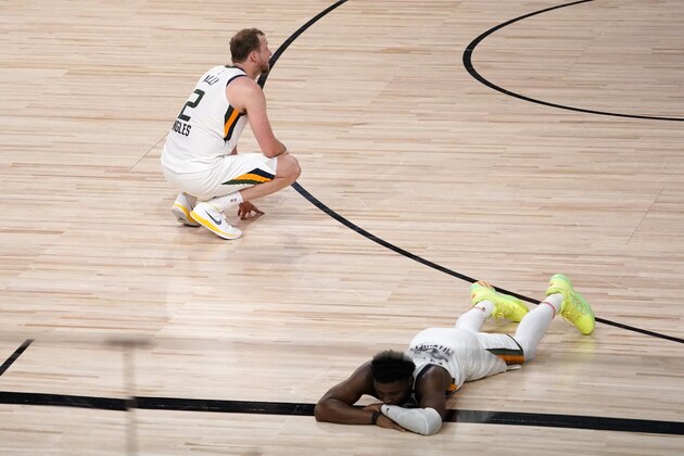 Utah Jazz's Joe Ingles (2) and Donovan Mitchell, bottom right, sit on the floor after their 80-78 loss to the Denver Nuggets during an NBA first round playoff basketball game, Tuesday, Sept. 1,2020, in Lake Buena Vista, Fla. (AP Photo/Mark J. Terrill)